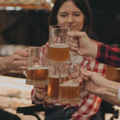 Many mugs of beer joining together in a toast
