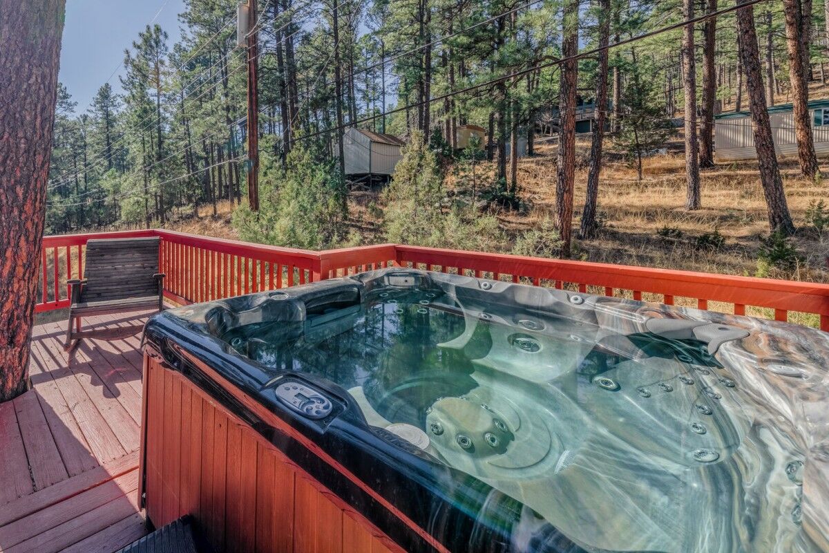 Outside patio of Willow House, a cabin rental in Ruidoso, NM. Featuring a hot tub.