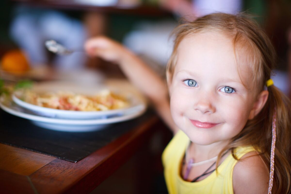 Young girl eating at buffet at Flying J Ranch in Ruidoso, NM
