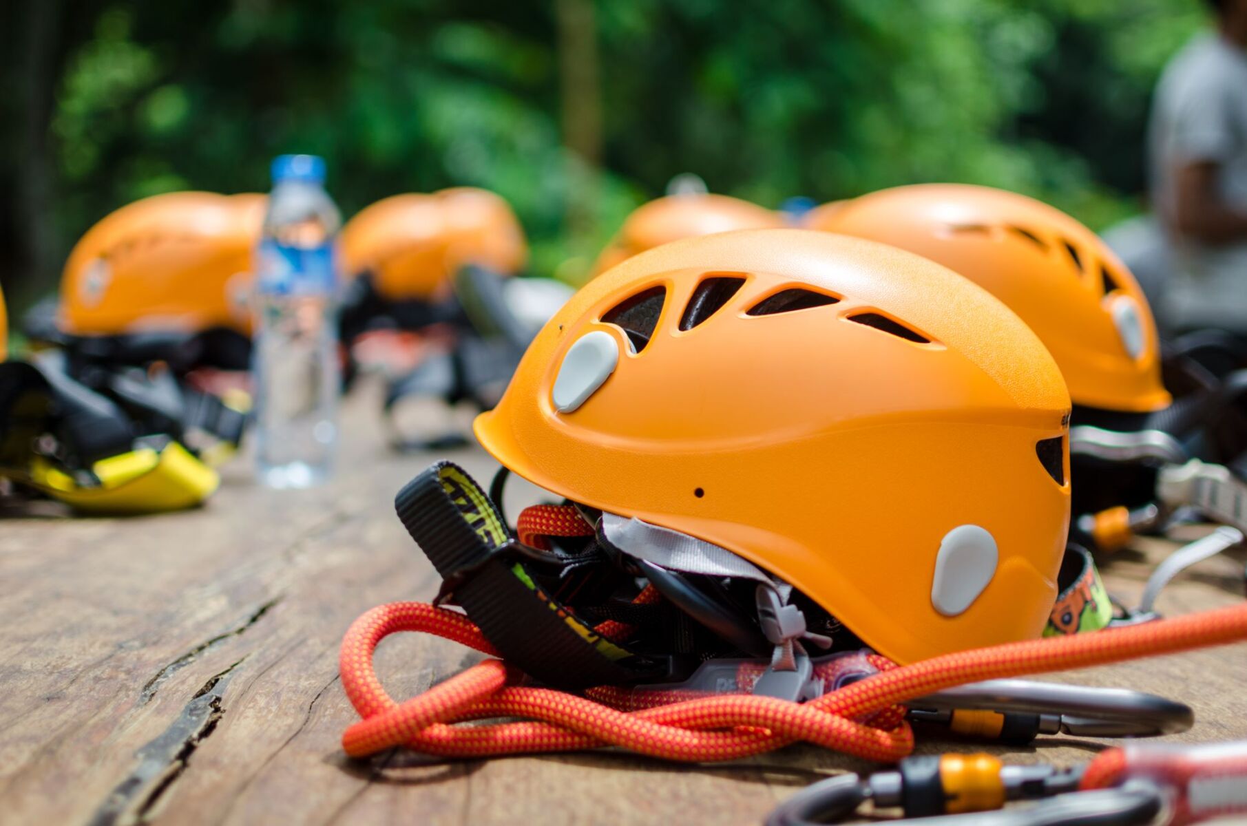 ziplining helmets lined up on a wooden table
