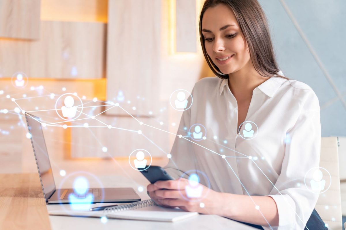 woman doing marketing on her phone and laptop
