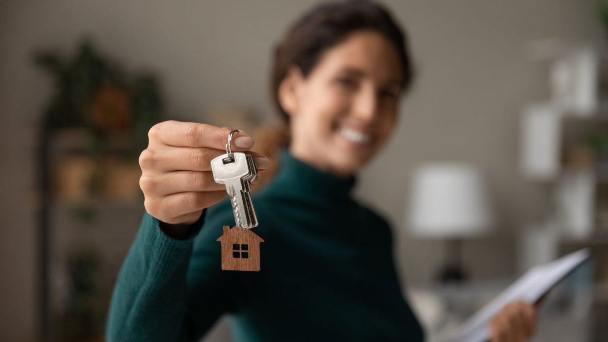 girl holding keys to home